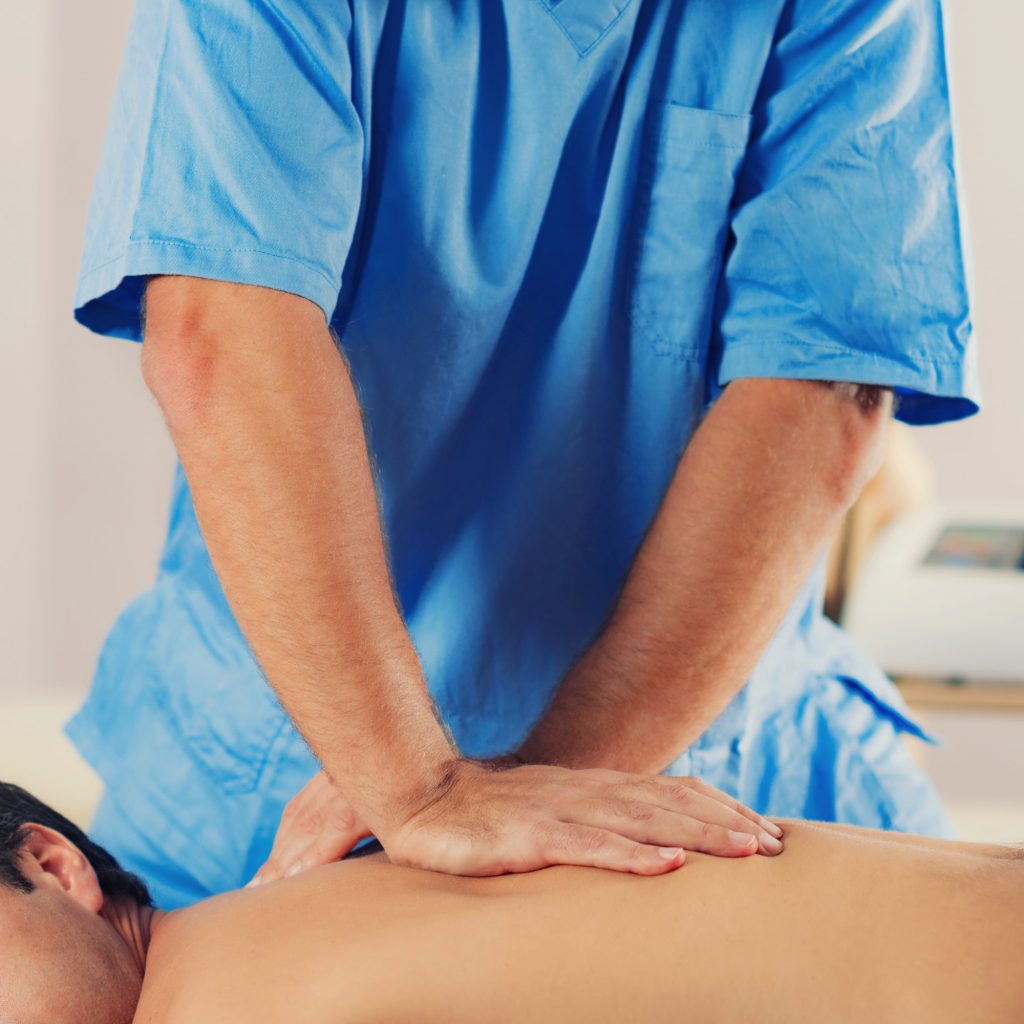 Physiotherapist Working With Patient Back